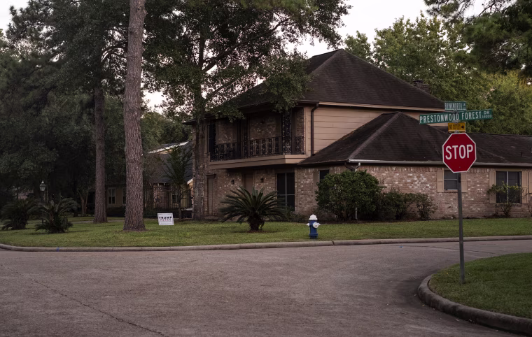 IMage: A large house with a Trump Pence campaign sign on the lawn in Prestonwood Foret.