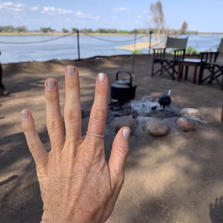 wearing my PAVOI ring at the firepit at Old Mondoro Lodge, a safari camp in Zambai