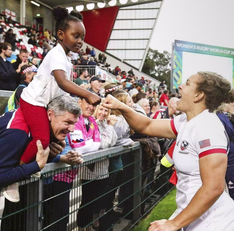 Naima Reddick greets a young fan.