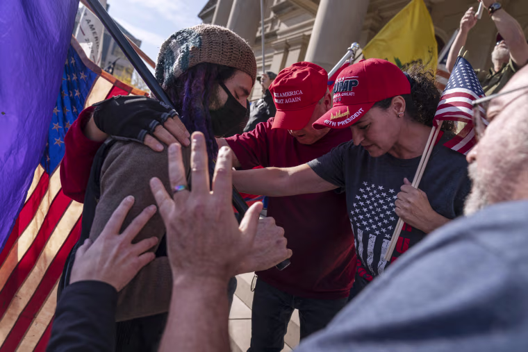 Trump supporters pray after the presidential election was called for Joe Biden outside the State Capitol in Lansing, Mich.