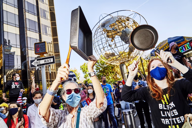 Image:New Yorkers bang pans as they celebrate in Columbus Circle.