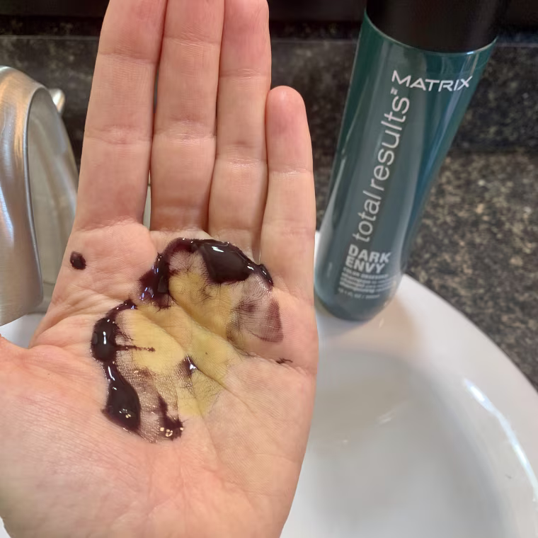 a yellow-green stain in my hand left behind from the shampoo