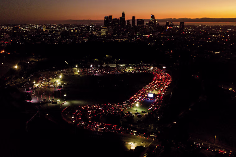 Image: Motorists wait in line outside Dodgers Stadium to take a coronavirus test