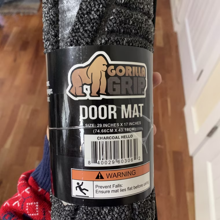 the Gorilla Grip Original Durable Natural Rubber Door Mat comes rolled up and takes a few hours before it lays flat