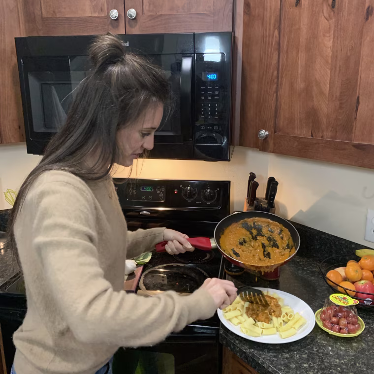 putting my pasta sauce on a plate of noodles