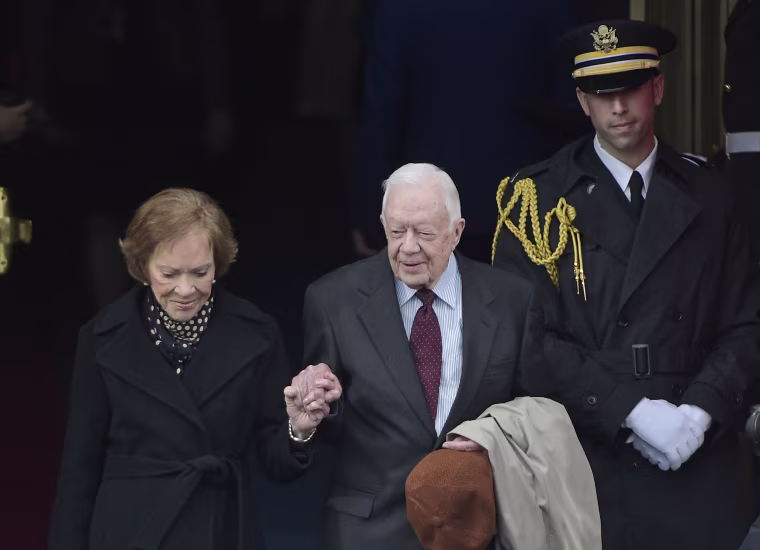 Former President Jimmy Carter and his wife Rosalynn Carter step attend President Donald Trump's inauguration on Jan. 20, 2017.