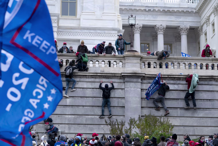Image: Protesters climb Capitol wall