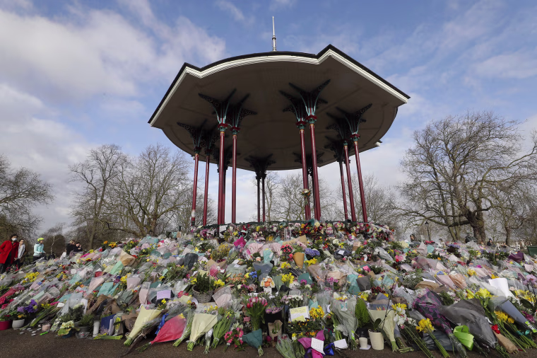 Image: Floral tributes and candles placed at the bandstand on Clapham Common, London