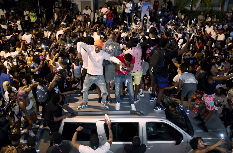 Image: People gather while exiting the area as an 8pm curfew goes into effect on March 21, 2021 in Miami Beach, Fla.
