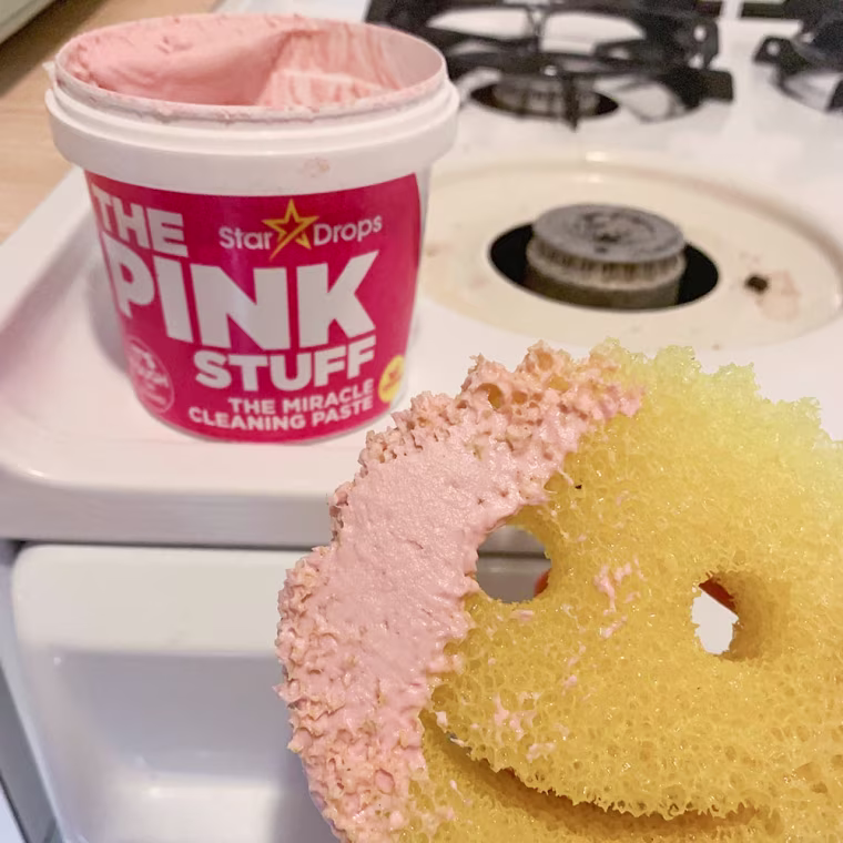 Emma Stessman shows a yellow sponge with The Pink Stuff used for cleaning tough stains