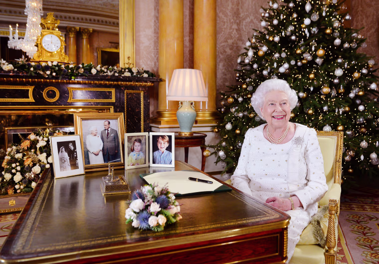 Image: Queen Elizabeth II sits at a desk in the 1844 Room at Buckingham Palace, after recording her Christmas Day broadcast to the Commonwealth at Buckingham Palace