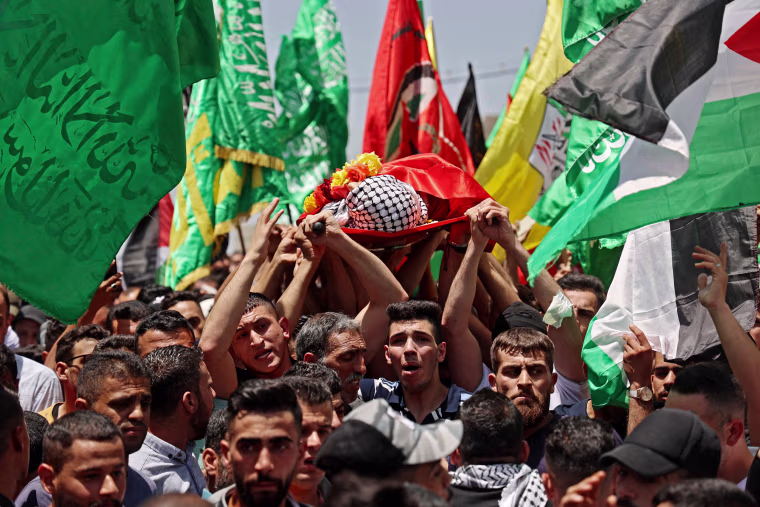 Mourners attend the funeral of Palestinian Rashid Abu Ara, 16, who was killed during clashes with Israeli troops in village of Aqaba near Nablus, West Bank, on May 12, 2021.