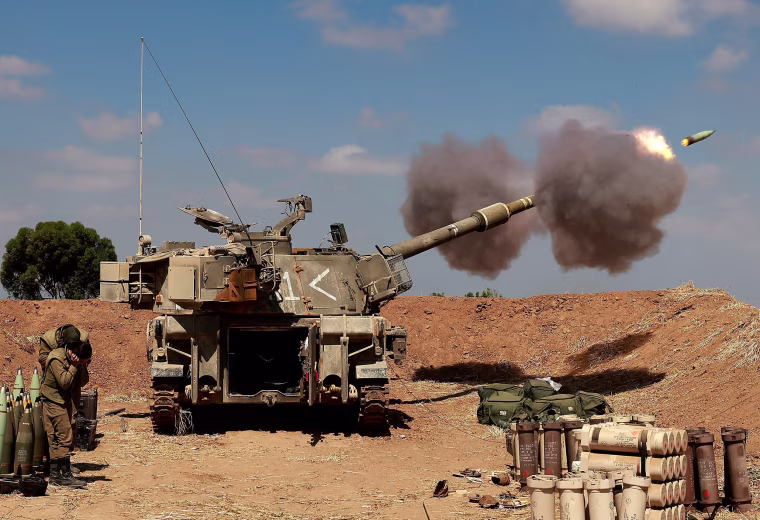 Israeli soldiers fire a 155mm self-propelled howitzer towards the Gaza Strip from their position near the southern Israeli city of Sderot on May 13.