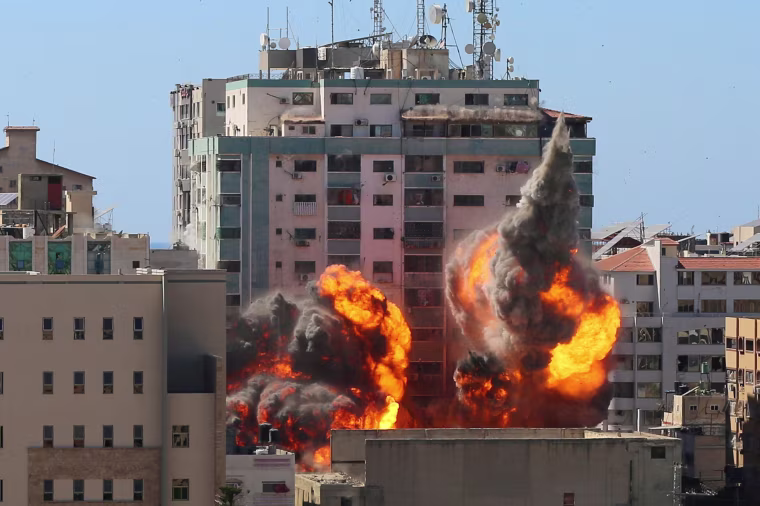 Image: A tower housing AP, Al-Jazeera offices collapses after Israeli missile strikes
