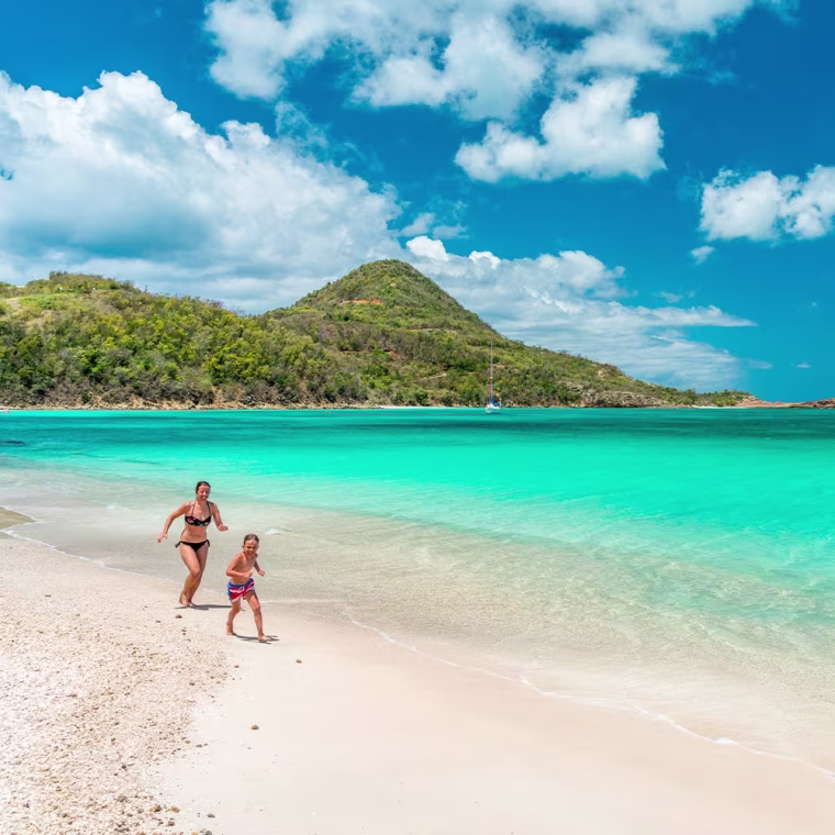 Mother and Son running on beach in St. Lucia