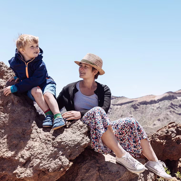 Mother and Son sitting on rock in Tenerife
