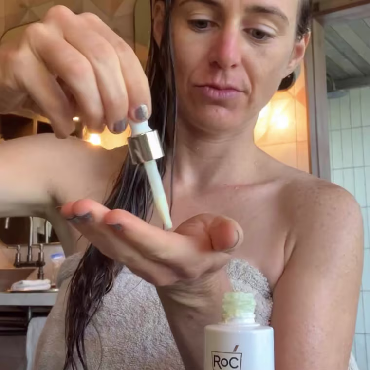 Katie Jackson putting a drop of RoC Retinol Serum on her hand.
