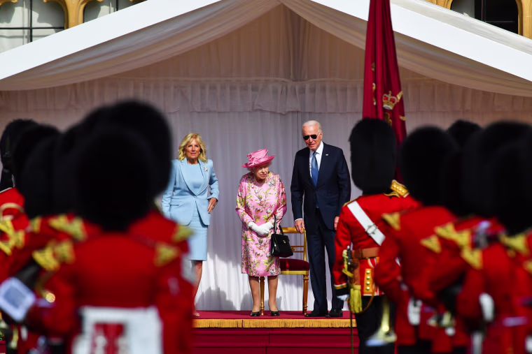 President Joe Biden, Jill Biden and Britain's Queen Elizabeth stand in front of members of the Royal Guard at Windsor Castle in Windsor, Britain, on June 13, 2021.
