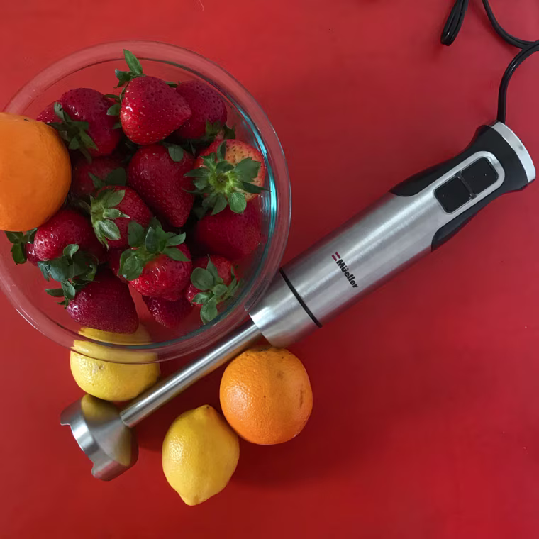 Overhead image of an immersion blender and fruit