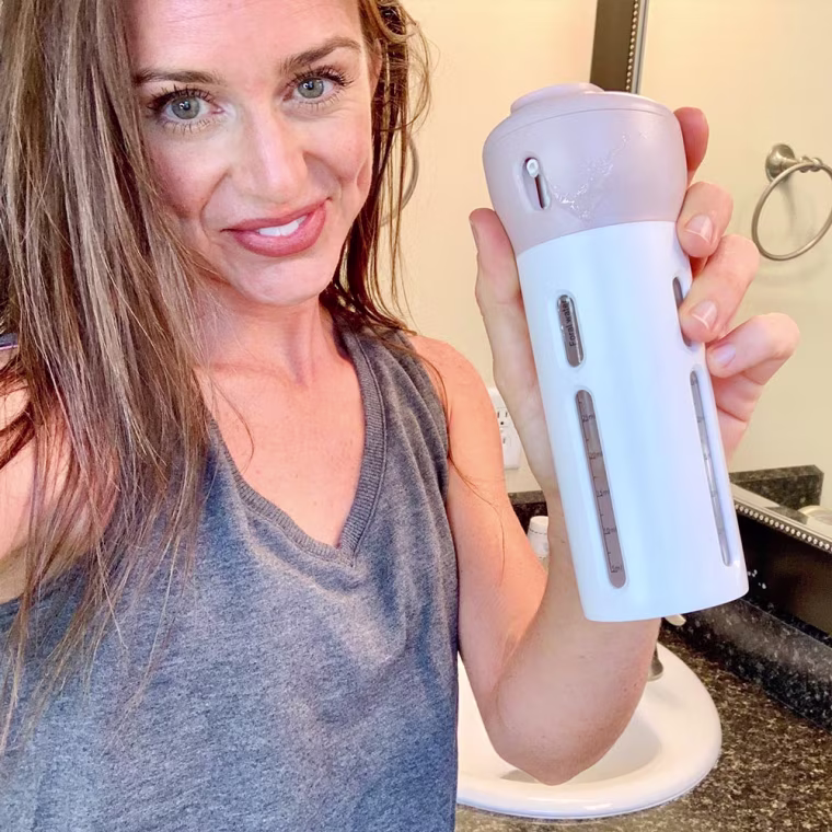 Katie Jackson holding up a 4-1 travel container