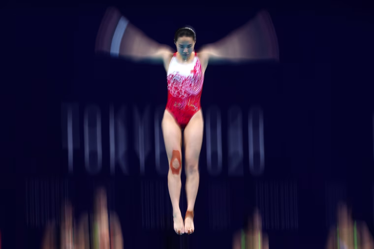 Han Wang of Team China warms up ahead of the Women's 3m Springboard Finals on day two of the Olympics at Tokyo Aquatics Centre on July 25, 2021.