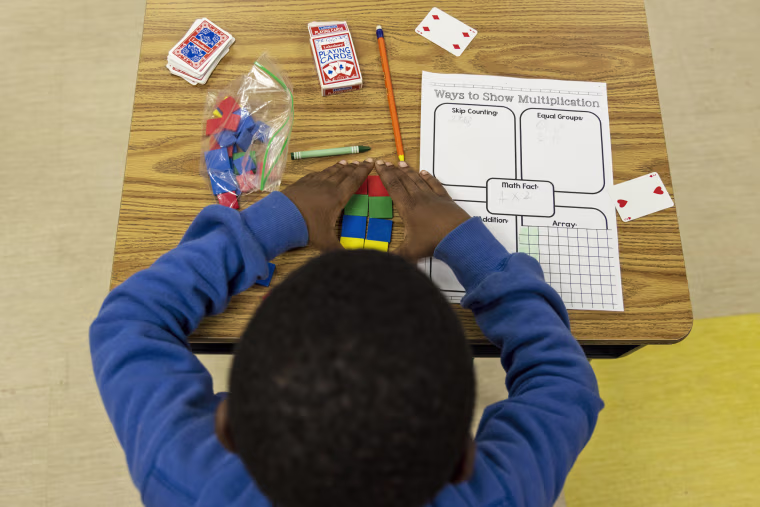 A student uses tiles while working on a multiplication problem at Ida Green Elementary.