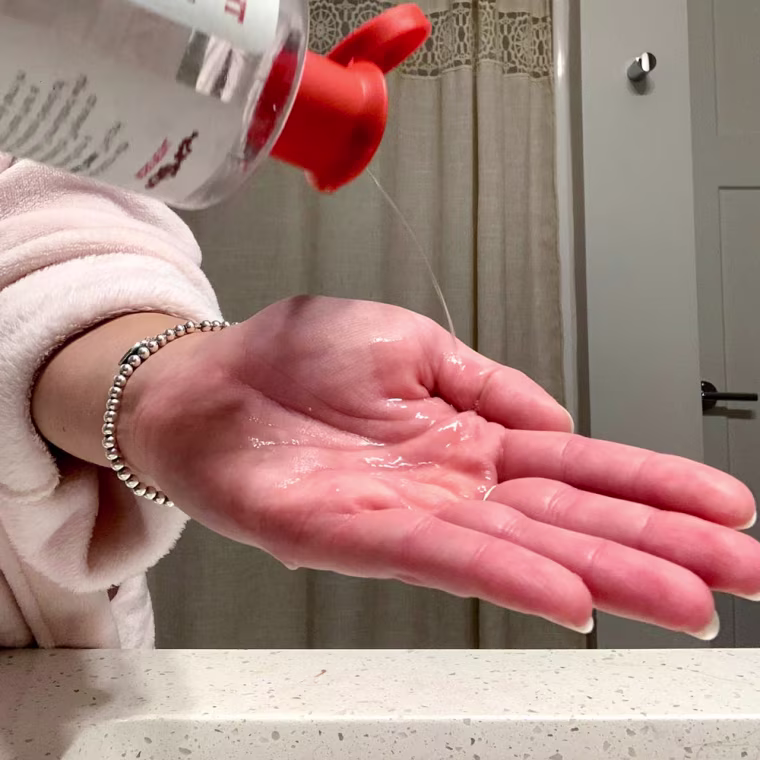 Writer Danielle Murphy pouring Thayers Facial Toner in her hand