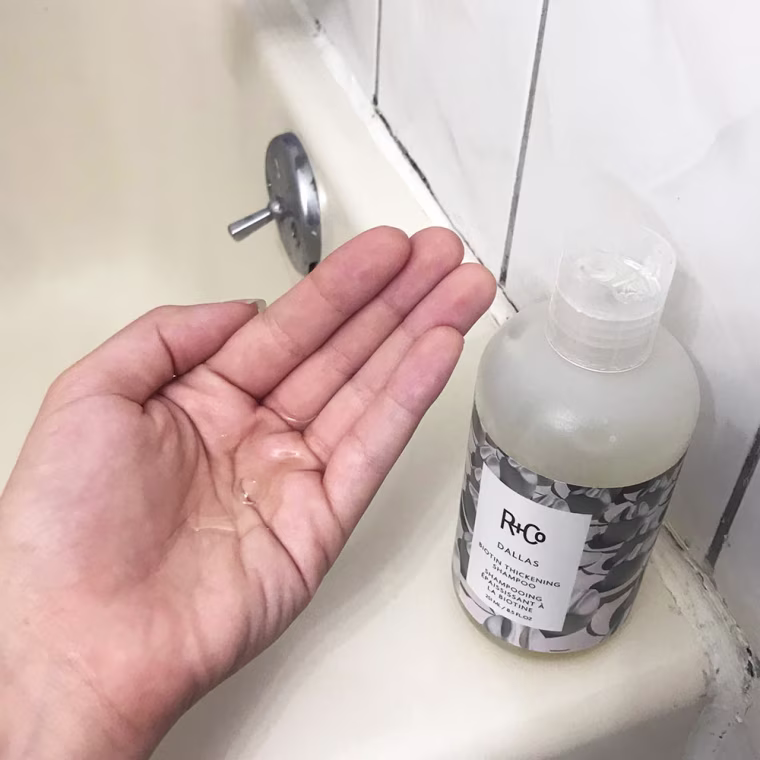 Image of Writer Cailey Rizzo holding Biotin shampoo