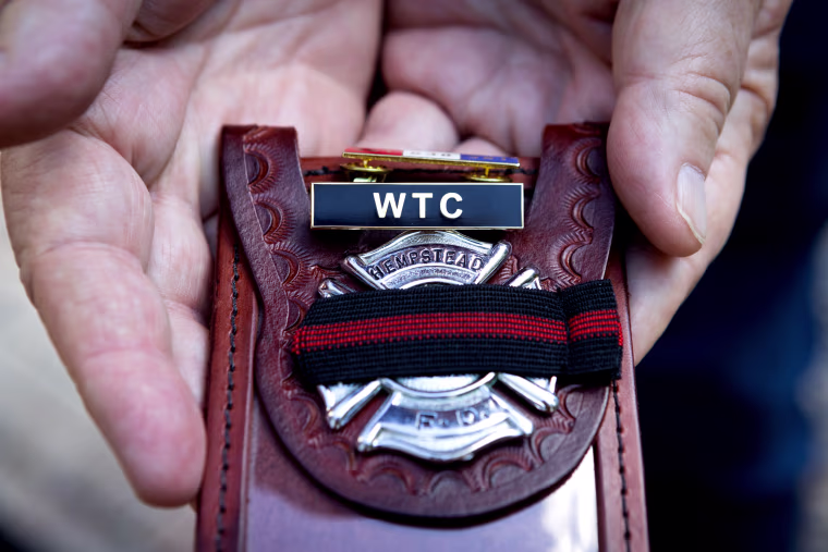 Kevin Maxwell shows the pins he received for his service and his badge.