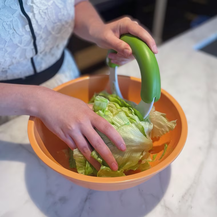 Writer Abigail Barr using a salad chopper famous on TikTok to chop up romaine lettuce