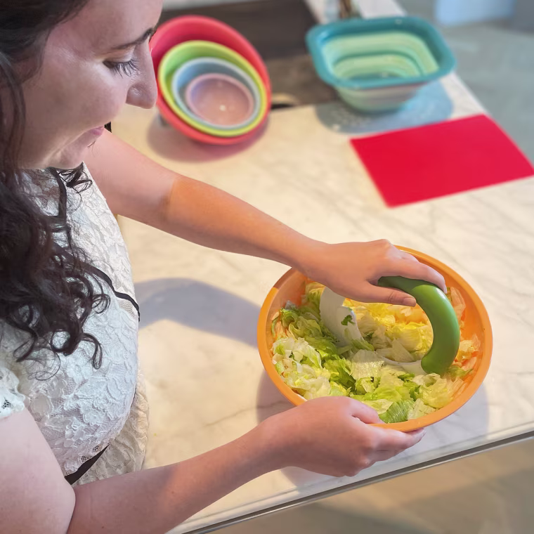image of Writer Abigail Barr using a salad chopper famous on TikTok to chop up romaine lettuce