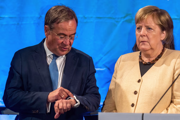 Angela Merkel stands next to Armin Laschet.