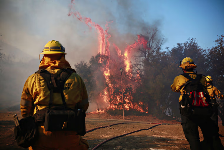 Image: Firefighters battle a blaze at the Salvation Army Camp