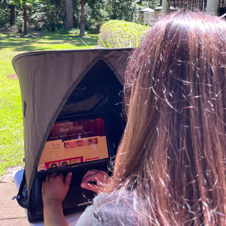 Editorial assistant Jillian Ortiz using the Vatalyst Laptop Sun Shade