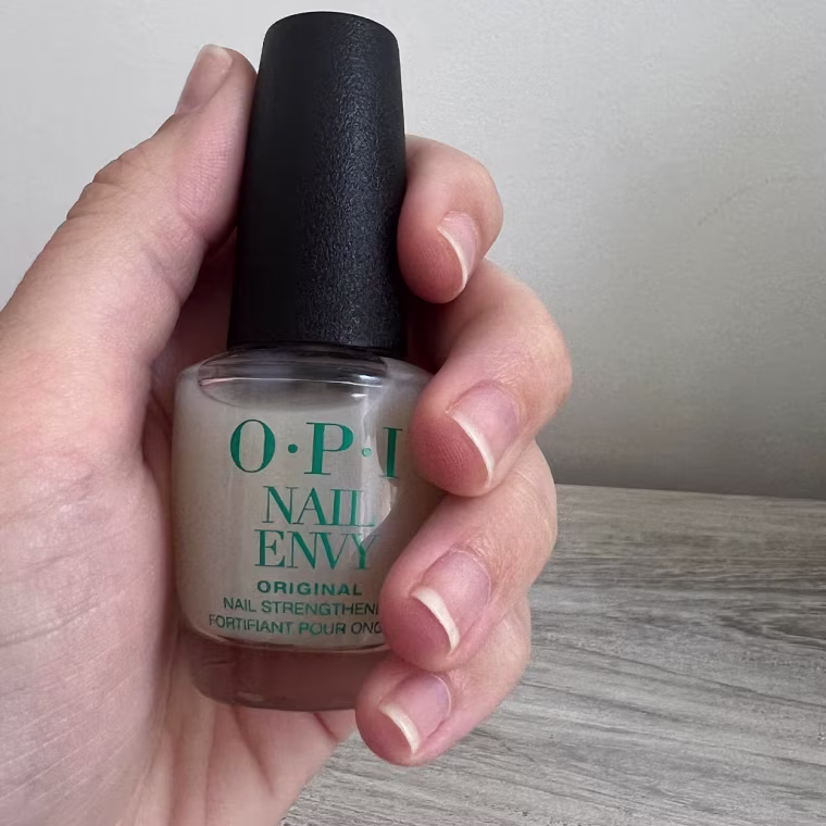 Hand holding OPI nail polish