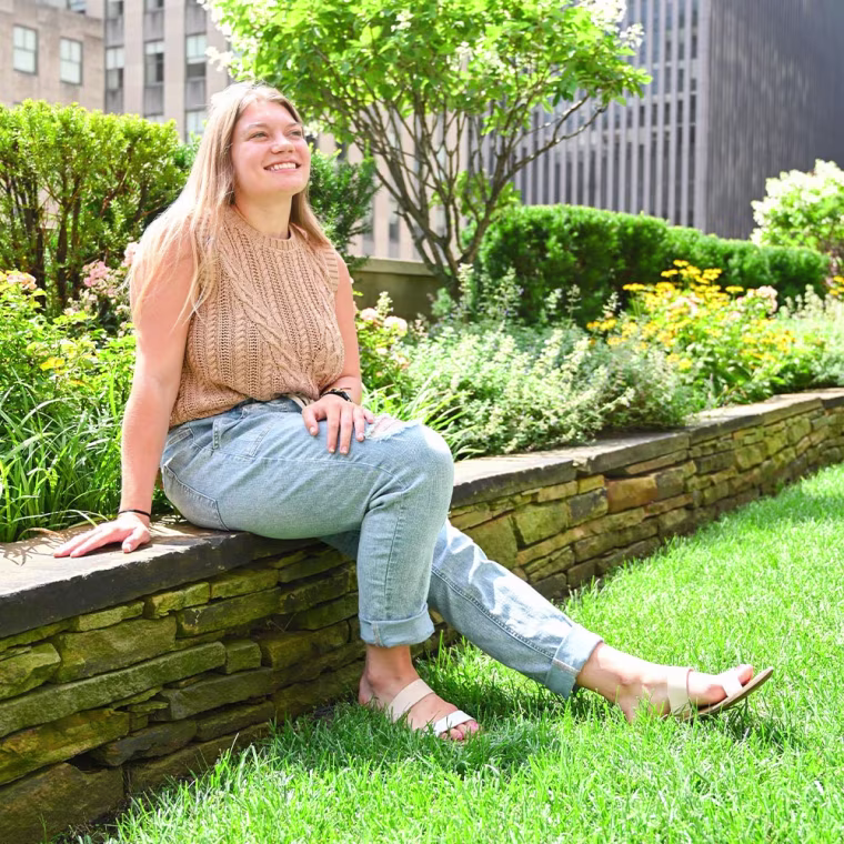 Woman sitting down outside in the sun