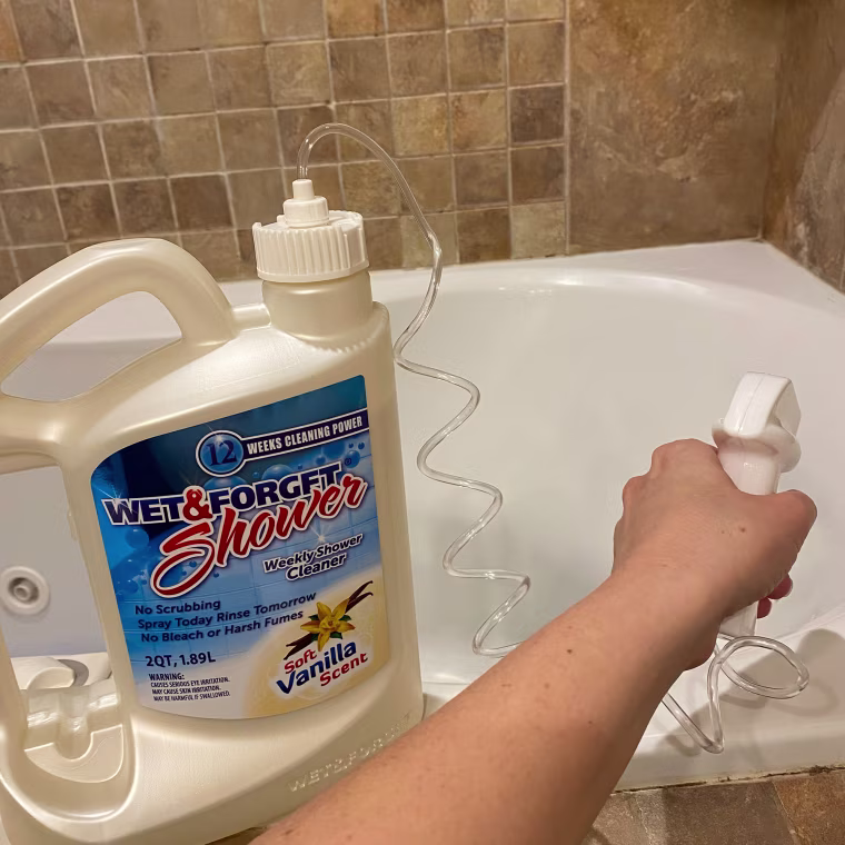 Woman spraying shower cleaner