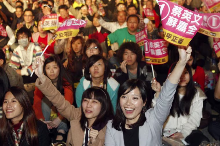 Supporters of Democratic Progressive Party Chairperson and presidential candidate Tsai Ing-wen monitor ballot counting broadcast on a screen at the campaign headquarters in Taipei