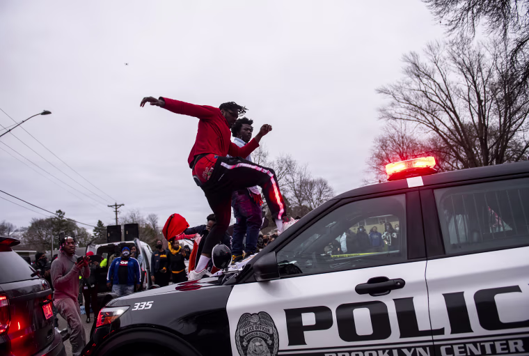 Image: A man stomps the windshield of a police cruiser as people protest after Brooklyn Center police shot and killed Daunte Wright during a traffic stop on April 11, 2021 in Brooklyn Center, Minn.