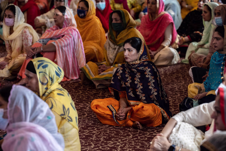 Image: Members the Sikh community in the prayer hall at the Sikh Satsang of Indianapolis on April 18, 2021.
