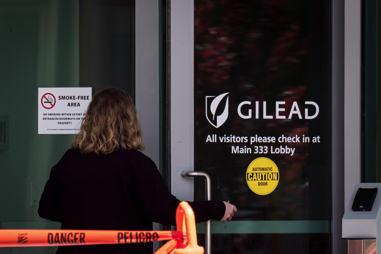 Image: A person enters a building at Gilead Sciences Inc. headquarters in Foster City, Calif., on March 19, 2020.