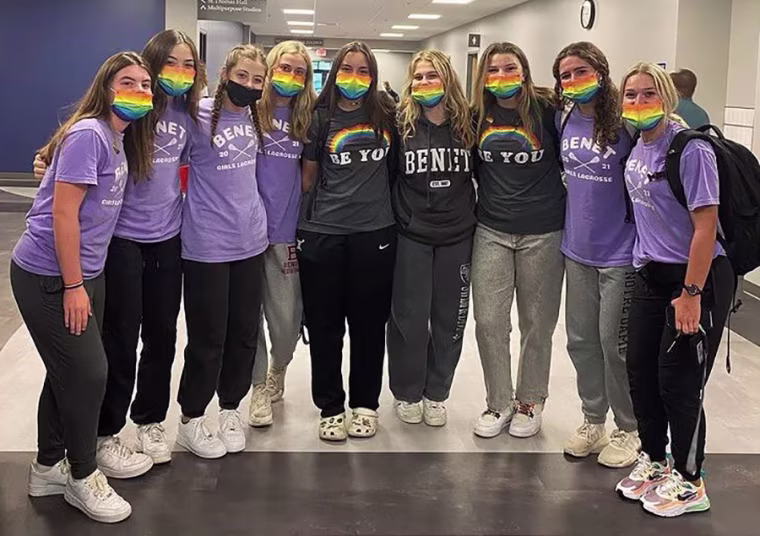 Image: Members of the Benet Academy lacrosse team wear rainbow Pride masks in support of Coach Amanda Kammes.