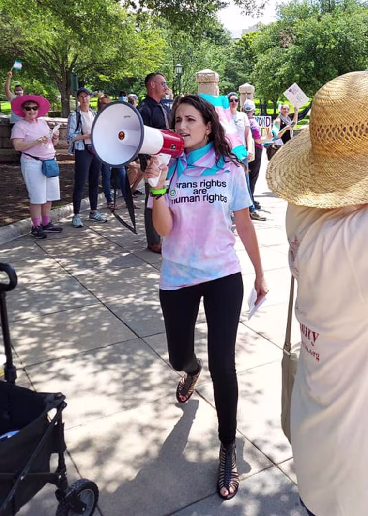 Image: Annaliese Cothron protests on behalf of her 8-year-old nonbinary child.