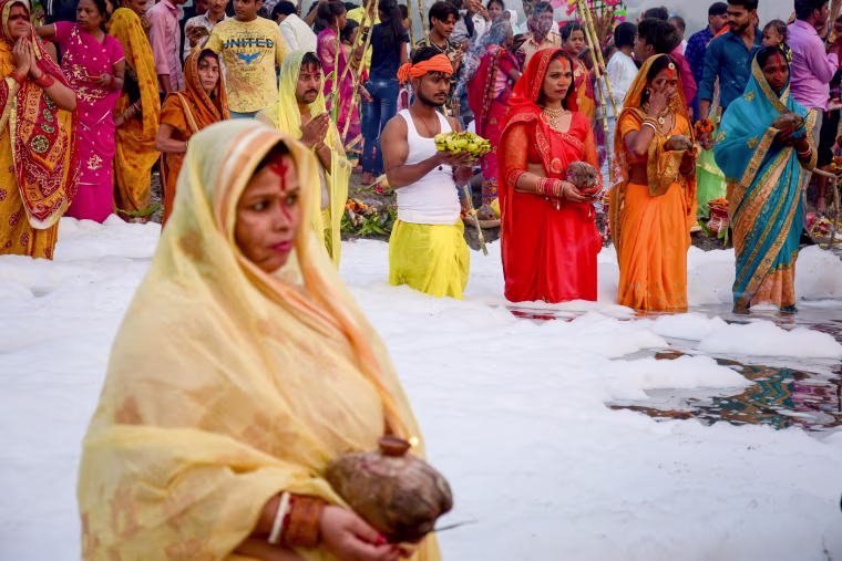 Devotees seen with some offerings worshiping the Sun god as