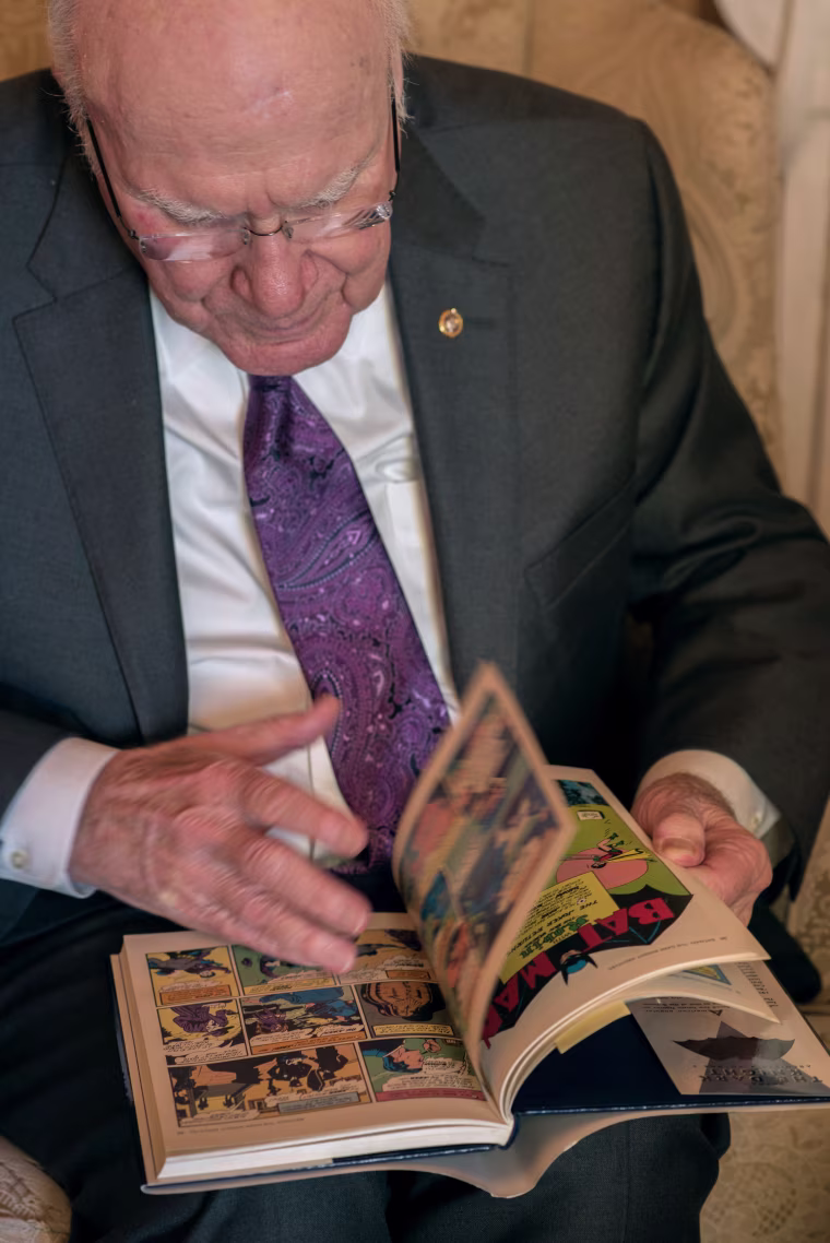 Sen. Patrick Leahy looks through "The Dark Night," a compilation of the first Batman comics for which he wrote an introduction, at his office on Capitol Hill in 2017.