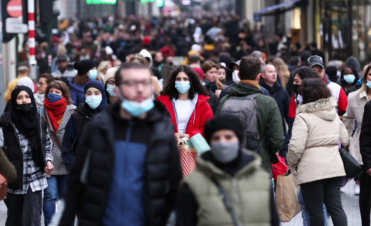 People walk on a street in Brussels on Nov. 20, 2021.