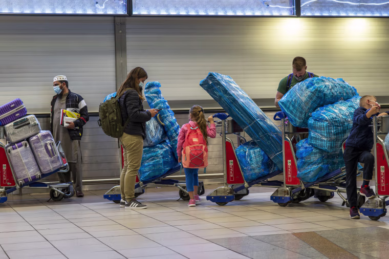 People lineup to get on an overseas flight at OR Tambo's airport in Johannesburg, South Africa, on Nov. 26, 2021.