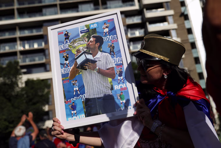 Image: Supporters gather outside the hotel where Novak Djokovic is believed to be held in Melbourne