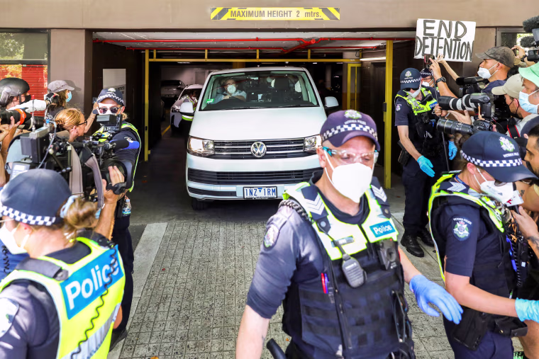 Image: Media surround a vehicle at the facility where Novak Djokovic has been held in Melbourne