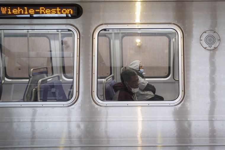 Image: Commuters ride trains in Falls Church, Va., on Feb. 1, 2021.